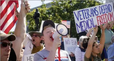  ?? Geoff forester / tHe concord monitor ?? demonstrat­ors attend a press conference that turned into a rally against vaccine mandates outside the state House in concord, n.H., on Wednesday.