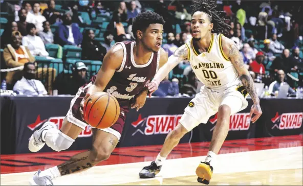  ?? BUTCH DILL/AP ?? TEXAS SOUTHERN GUARD PJ HENRY (3) drives to the basket around Grambling State guard Virshon Cotton (00) during the second half of a game in the championsh­ip of the Southweste­rn Athletic Conference tournament on Saturday in Birmingham, Ala.