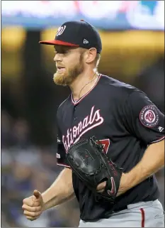  ?? MARK J. TERRILL — THE ASSOCIATED PRESS ?? Nationals starting pitcher Stephen Strasburg smiles after the last out in the third inning against the Dodgers in Game 2 the National League Division Series on Friday in Los Angeles. He gets the ball in Game 3of the NLCS Monday.