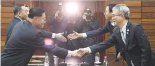  ?? (Reuters) ?? KWON HYOK BONG from North Korea’s Culture Ministry, shakes hands with Lee Woo-sung, head of South Korea’s Culture and Arts Policy Office, after their meeting in the truce village of Panmunjom yesterday.