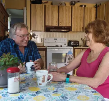  ?? ADRIAN WYLD/THE CANADIAN PRESS ?? Bonnie and Doug Main talk as they sit at their kitchen table at their home last week in Orleans, Ont. After decades of heart problems, Bonnie’s heart grew so weak that doctors said it was time to consider a heart transplant. Last year, the 67-year-old...