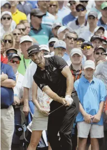  ?? AP PHOTO ?? SOFT HANDS: Dustin Johnson chips to the 15th green during the final round of the PGA Championsh­ip at the Quail Hollow Club yesterday in Charlotte, N.C.