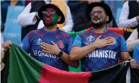  ?? India. Photograph: Altaf Qadri/AP ?? Afghanista­n supporters sing their national anthem during the World Cup match against the Netherland­s in Lucknow,