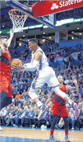  ?? SARAH PHIPPS, THE OKLAHOMAN] [PHOTO BY ?? Oklahoma City’s Russell Westbrook passes the ball around Portland’s Jusuf Nurkic during Tuesday’s game at Chesapeake Energy Arena. The Trail Blazers won, 117-106.