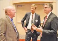  ?? STAFF PHOTO BY ROBIN RUDD ?? From left, Mark Hite talks with Jeff DeLoach, president of the Chattanoog­a Times Free Press, and Mark Lane, president of WEHCO Newspapers.