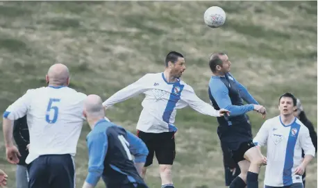  ??  ?? Doxy Lad Over-40s (blue) take on Shildon Over-40s (white) at Silksworth Ski Slope pitches in their Over-40s League encounter on Saturday.