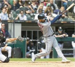  ?? BRIAN CASSELLA/CHICAGO TRIBUNE ?? Guardians catcher Cam Gallagher hits an RBI single in the seventh inning on Thursday.