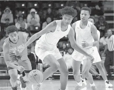  ?? KARL MERTON FERRON/THE BALTIMORE SUN ?? Oak Hill Academy (Va.) Warriors guard Cam Thomas watches St. Frances Academy forward Julian Reese (10) steal the ball following a double team with guard Adrian Baldwin during the East Coast Bump tournament Saturday at UMBC.