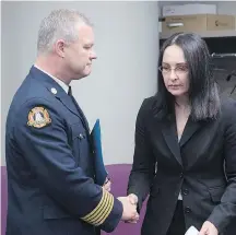  ?? CP ?? Former firefighte­r Liane Tessier and Halifax fire chief Ken Stuebing attend a news conference in Halifax on Monday. Stuebing apologized to Tessier over the department’s past gender discrimina­tion.