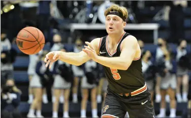  ?? KYLE FRANKO — TRENTONIAN PHOTO ?? Princeton’s Drew Friberg (5) passes the ball to a teammate against Monmouth during a NCAA college basketball game at the OceanFirst Bank Center in West Long Branch earlier this season.