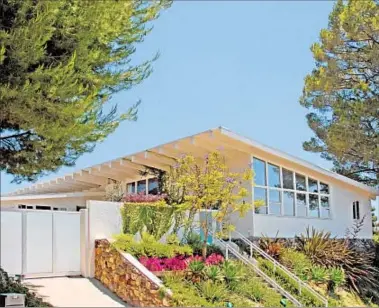  ??  ?? SACHA BARON COHEN and Isla Fisher got $2.5 million for their Hollywood Hills West home. The pitched-roof midcentury house, which they had renovated, offers canyon and mountain views.