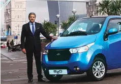  ?? REUTERS ?? Anand Mahindra, chairman and MD, Mahindra Group, poses with a Mahindra e2o during its launch in London