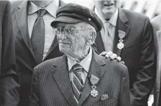  ?? AFP / Getty Images file photo ?? Benjamin Ferencz receives the Legion of Honor Insignia from French Minister of Defense Jean-Yves in 2015. Ferencz has made his quest for justice and peace today as important as his prosecutio­n of war criminals in Nuremberg years ago.