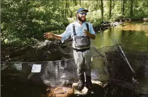  ?? Arnold Gold / Hearst Connecticu­t Media file photo ?? Jon Vander Werff, fish biologist with Save the Sound, stands in front of a diadromous fish research trap at Konold’s Pond in Woodbridge June 23, 2021. The trap allows Vander Werff to obtain estimates of fish population­s and the times that they swim upstream to spawn.