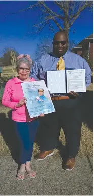  ?? Submitted photo ?? Patricia Genovese receives a document from Jason McGhee, a spokesman for U.S. Rep. Bruce Westerman.