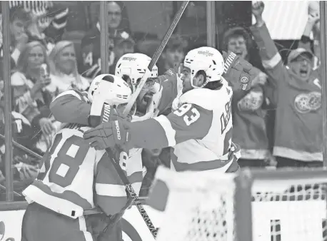  ?? NICK TURCHIARO/USA TODAY SPORTS ?? Red Wings center Dylan Larkin scores the winning goal and celebrates with right wing Alex DeBrincat (93) during the overtime period of Saturday’s 5-4 win in Toronto.