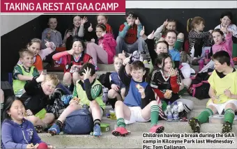  ??  ?? Children having a break during the GAA camp in Kilcoyne Park last Wednesday. Pic: Tom Callanan.