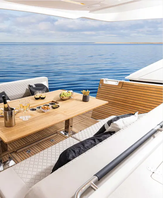  ?? ?? The sun pad aft serves double duty as a bench seat for alfresco dining. Note the diamond-pattern stitching.