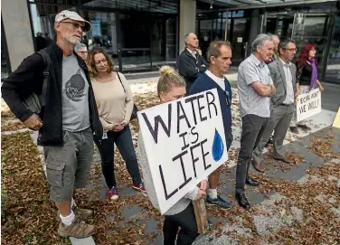 ?? PHOTO: ALDEN WILLIAMS/STUFF ?? Anti-water bottling protesters supported campaign group Aotearoa Water Action as they handed in a petition to ECan yesterday.