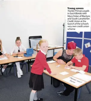  ??  ?? Young savers Hunter Primary pupils in East Kilbride with Myra Dolan of Blantyre and South Lanarkshir­e Credit Union at the launch of the school’s very own credit union scheme