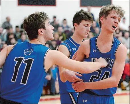  ?? SARAH GORDON/THE DAY ?? Old Lyme’s Liam Halloway (11) tries to comfort teammate Quinn Romeo (24) after a foul was called during the fourth quarter of Monday night’s Shoreline Conference showdown at Cromwell. The Wildcats, who trailed 40-29 after three quarters, rallied to take a late 48-47 lead before the Panthers pulled out a 50-48 win. Cromwell won the regular-season title and remained unbeaten at 20-0.