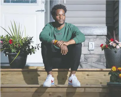  ?? BRANDON HARDER ?? Christian Mbanza sits on the steps of his home in Regina on Thursday. He was racially profiled while going for a bike ride. A post was made to a community group on Facebook accusing him of stealing from cars in the neighbourh­ood. The car he was accused of stealing from was his own.