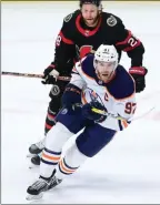  ?? The Canadian Press ?? Edmonton Oilers centre Connor McDavid skates past Ottawa Senators right-wing Connor Brown in Ottawa on Tuesday.