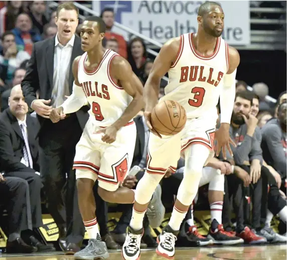  ?? | MATTMARTON/ AP ?? The Bulls’ front office faces tough decisions about the futures of guards Rajon Rondo ( left) and DwyaneWade as they embark on a rebuilding project.