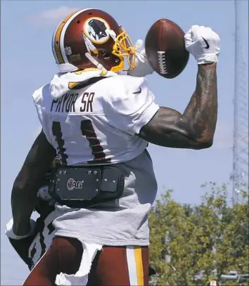  ??  ?? Terrelle Pryor Sr. goes up for a pass in Washington’s camp in Richmond, Va., earlier this week. In just his second full season as a receiver, the Redskins are hoping he can fill a void for them at the position.