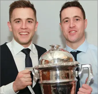  ??  ?? Captain of Newtown Blues Senior Championsh­ip winners Andy Mc Donnell & teammate James Murray with Joe Ward Cup at the Blues awards night. Picture: Kieran Carr.