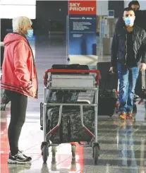  ?? GAVIN YOUNG ?? Travellers move through Calgary Internatio­nal Airport, where rapid testing for COVID-19 is being offered.