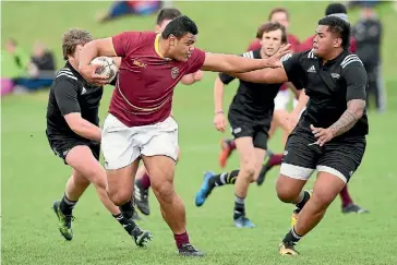  ?? KERRY MARSHALL/GETTY IMAGES ?? Southland under-19 No 8 Viliami Tosi looks to put a fend on a Heartland XV player at the national under-19 tournament in Taupo.