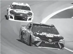  ?? Rick Scuteri/Associated Press ?? ■ Monster Energy NASCAR Cup Series driver Martin Truex Jr. (78) leads Chase Elliott on the 25th lap during a NASCAR Cup Series auto race Sunday in Avondale, Ariz.