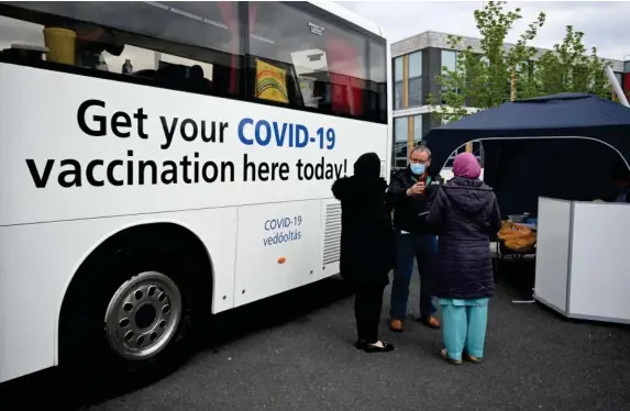  ?? (AFP/Getty) ?? A vaccine bus has been set up in Bolton to help with the uptake