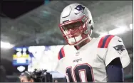  ?? Mark Brown / Getty Images ?? Patriots quarterbac­k Mac Jones walks off the field after losing to the Dolphins on Sunday.