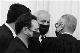  ?? MAYA ALLERUZZO / AP (POOL) ?? Former Israeli Prime Minister Benjamin Netanyahu, third from left, is flanked by lawyers before testimony by star witness Nir Hefetz, a former aide, Monday in his corruption trial at the District Court in east Jerusalem.