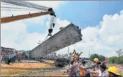  ?? PTI FILE ?? A mangled coach being lifted off the tracks by a crane at the accident site in Khatauli near Muzaffarna­gar.