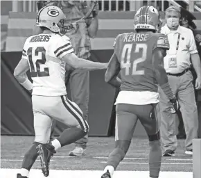  ?? PAUL SANCYA, AP ?? Green Bay Packers quarterbac­k Aaron Rodgers scrambles for a 6-yard touchdown during the second half of an NFL football game against the Detroit Lions, Sunday, Dec. 13, 2020, in Detroit.