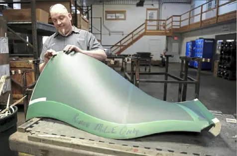  ?? Pam Panchak/Post-Gazette photos ?? John Maurin prepares an airplane blade for another step in the milling process at Tech Met Inc.