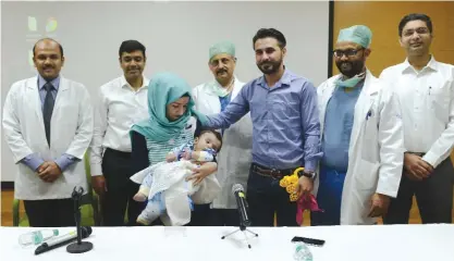  ??  ?? NOIDA: Iraqi parents Gufran Ali (3L) and Sarwed Ahmed Nadar (3R) pose with their eight-month-old son Karam (C) and physicians: Executive Consultant, paediatric surgery Abhishek (L), Senior Consultant, plastic and reconstruc­tive surgery Ashish Rai,...