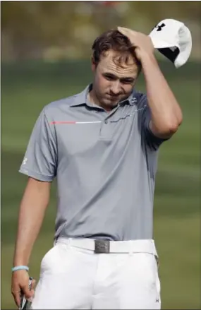  ??  ?? Jordan Spieth wipes his head after losing the 17th hole against Ernie Els in the quarterfin­als of the Match Play Championsh­ip on Saturday.