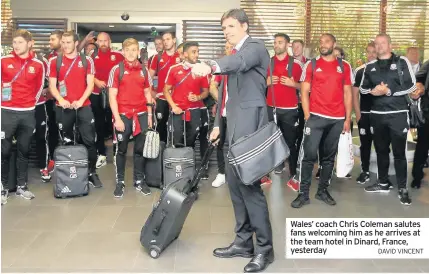  ?? DAVID VINCENT ?? Wales’ coach Chris Coleman salutes fans welcoming him as he arrives at the team hotel in Dinard, France, yesterday