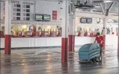  ?? Skip Dickstein / Special to the Times Union. ?? Even without fans the work continues make sure the facility is clean and sanitary the day before opening day at Saratoga.