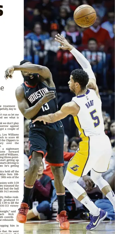  ?? — AP ?? Take that: Houston Rockets guard James Harden (left) passing the ball over Los Angeles Lakers guard Josh Hart in the first half of their NBA game on Sunday.