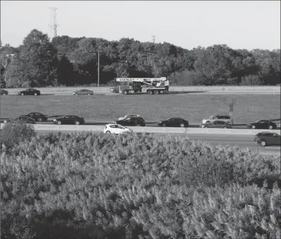  ?? Photo by Joseph B. Nadeau ?? Traffic along I-195 returned to normal by Tuesday afternoon but was snarled for most of the day on Tuesday as police worked to help the victims and then investigat­e at the scene of a deadly chain reaction crash that killed two men.