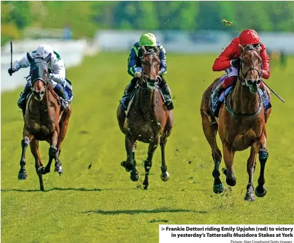  ?? Picture: Alan Crowhurst/Getty Images ?? Frankie Dettori riding Emily Upjohn (red) to victory in yesterday’s Tattersall­s Musidora Stakes at York