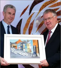  ?? All photos by Domnick Walsh ?? Munster Joinery founder Donal Ring presents 2018 Cantillon Business Leader Award of the Year winner Tomás Garvey (right) with a painting of Strand Street, Dingle, where Garvey’s original shop was located.