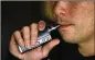  ?? GETTY IMAGES ?? Like other e-cigarettes, Juul is an electronic device that turns liquid into an inhalable vapor.