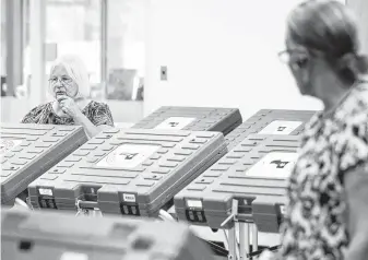  ?? Jon Shapley / Staff photograph­er ?? Mae Huckabay, left, works to set up a voting location at the West Gray Metropolit­an Multi-Services Center. The turnout for a $2.5 billion flood bond vote could be less than 8 percent.