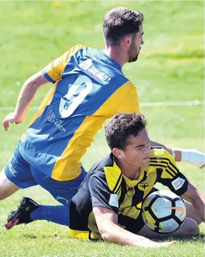  ?? PHOTO: PETER MCINTOSH ?? Blowing over . . . Southern United striker Garbhan Coughlan and Phoenix defender Liam Moore clash at Sunnyvale yesterday.